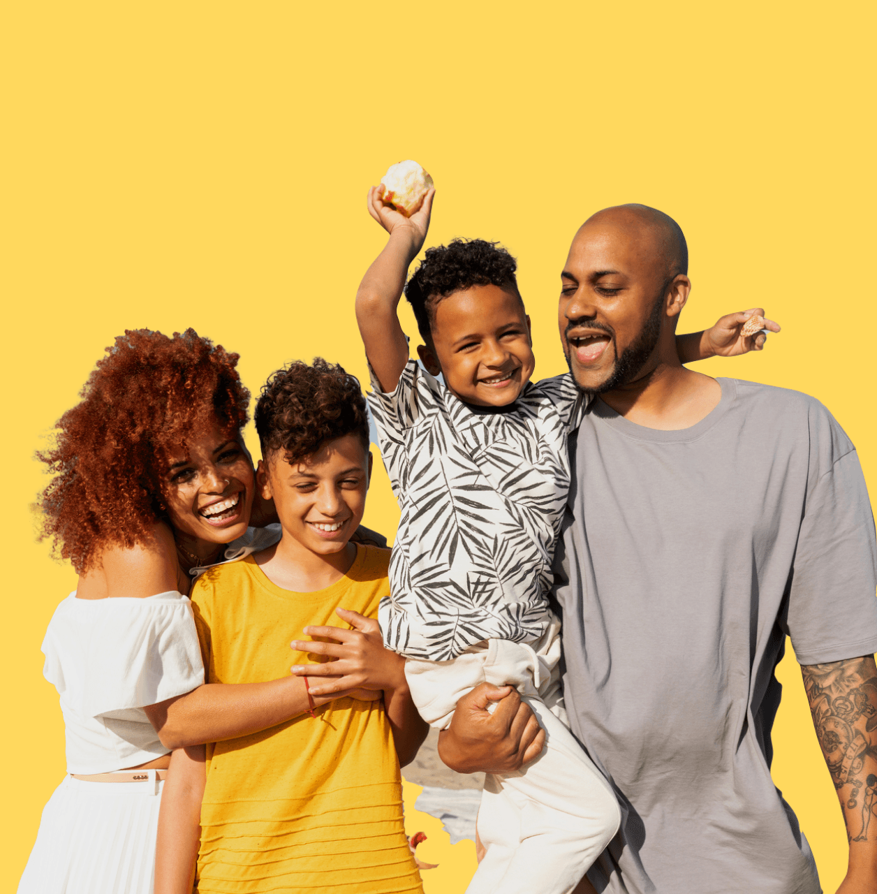 Mom, dad, and two sons, a tween and kindergartener, smiling and laughing together